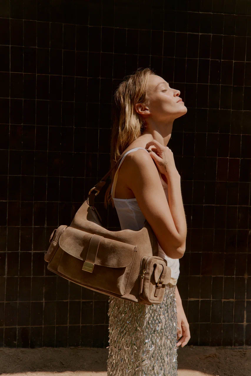 Model carrying a MISA suede bag